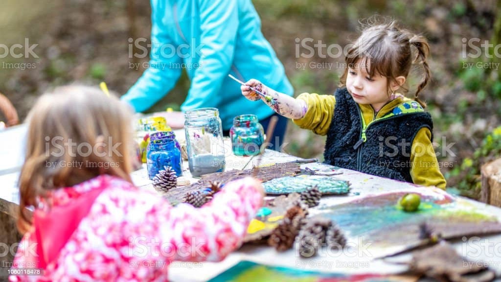 Stock photo of children painting. 